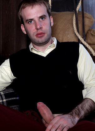 Gay stud masturbating his hard cock inside a barn